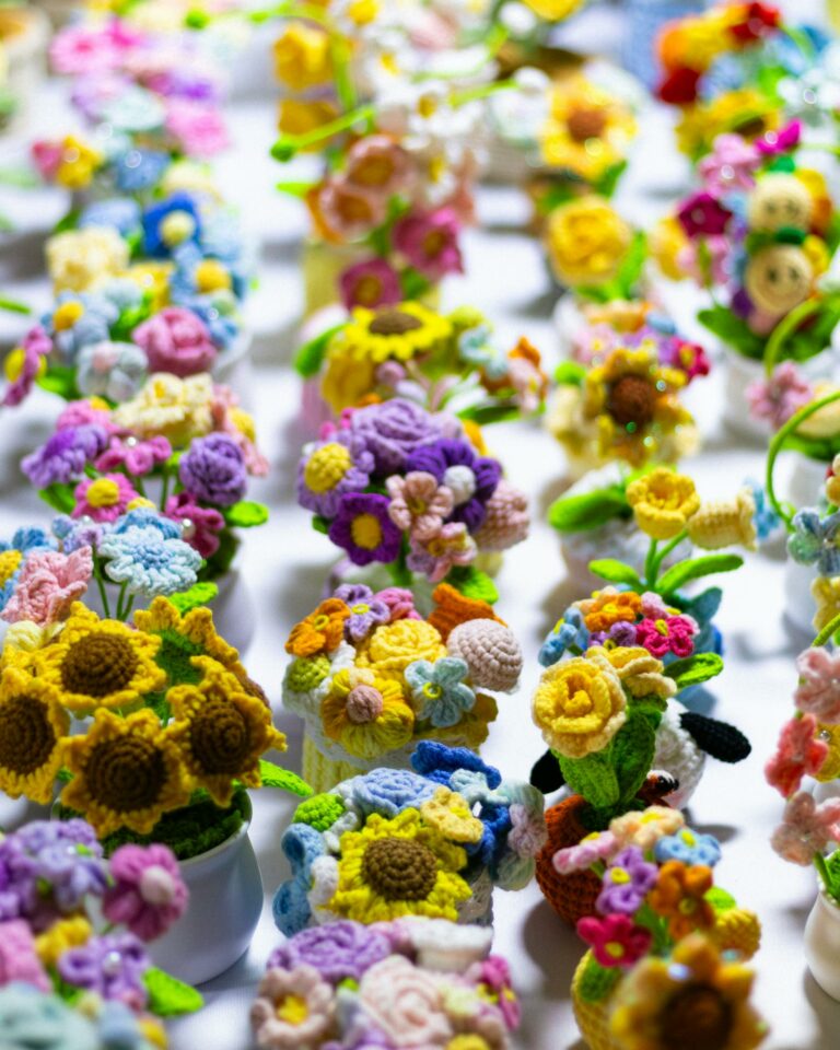 Vibrant crochet flower bouquets in various colors creating a cheerful display.